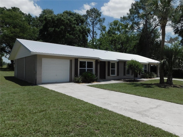 721 Town Ct Unit A & B, Bronson, FL 32621 - ranch-style house featuring a garage, a front lawn, concrete driveway, and stucco siding