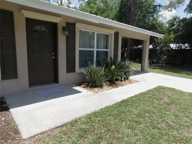721 Town Ct Unit A & B, Bronson, FL 32621 - entrance to property featuring a lawn and stucco siding