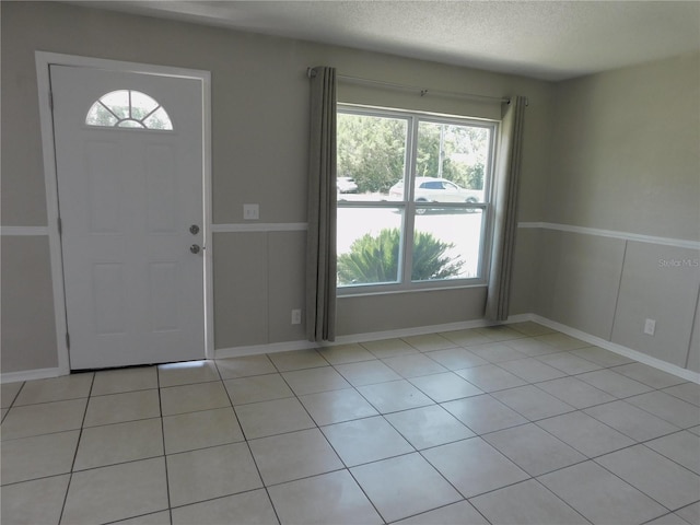 721 Town Ct Unit A & B, Bronson, FL 32621 - foyer entrance featuring healthy amount of natural light, baseboards, light tile patterned floors, and a textured ceiling