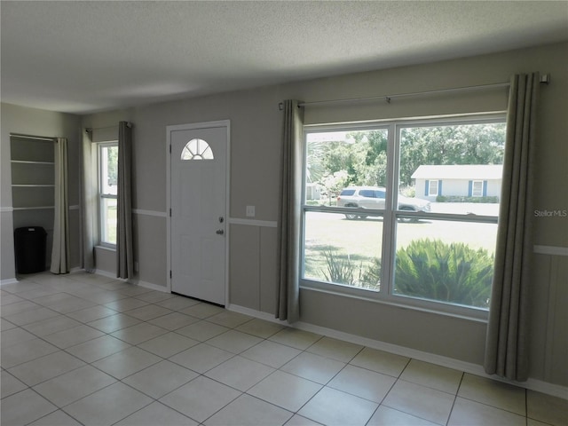 721 Town Ct Unit A & B, Bronson, FL 32621 - entrance foyer featuring healthy amount of natural light, a textured ceiling, baseboards, and light tile patterned floors
