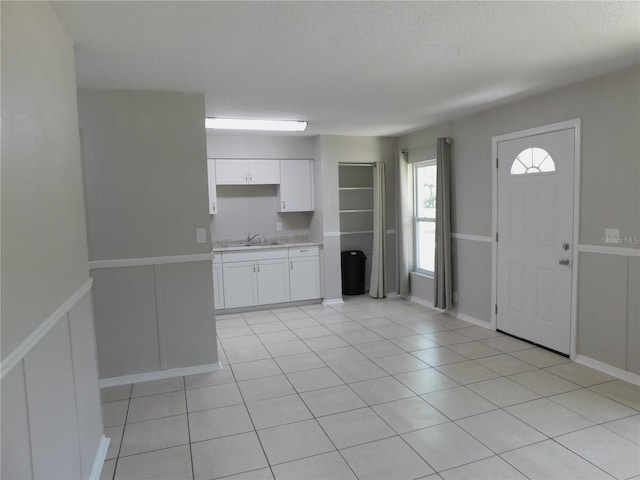 721 Town Ct Unit A & B, Bronson, FL 32621 - kitchen featuring white cabinetry, light countertops, light tile patterned floors, a textured ceiling, and a sink