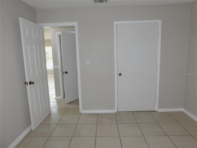 721 Town Ct Unit A & B, Bronson, FL 32621 - unfurnished bedroom with light tile patterned floors and baseboards