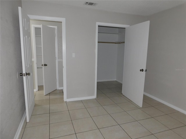 721 Town Ct Unit A & B, Bronson, FL 32621 - unfurnished bedroom featuring light tile patterned flooring, a closet, and baseboards