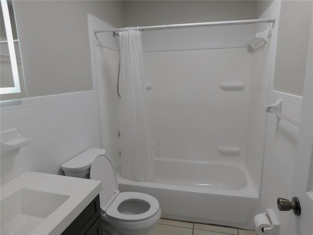 721 Town Ct Unit A & B, Bronson, FL 32621 - full bathroom featuring a wainscoted wall, toilet, tile walls, tile patterned flooring, and shower / bathtub combination with curtain