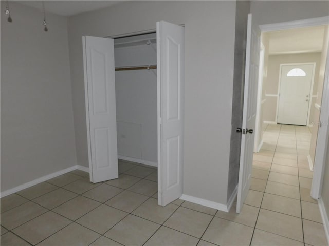 721 Town Ct Unit A & B, Bronson, FL 32621 - unfurnished bedroom with light tile patterned floors, baseboards, and a closet