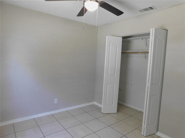 721 Town Ct Unit A & B, Bronson, FL 32621 - unfurnished bedroom featuring baseboards, light tile patterned floors, a closet, and ceiling fan