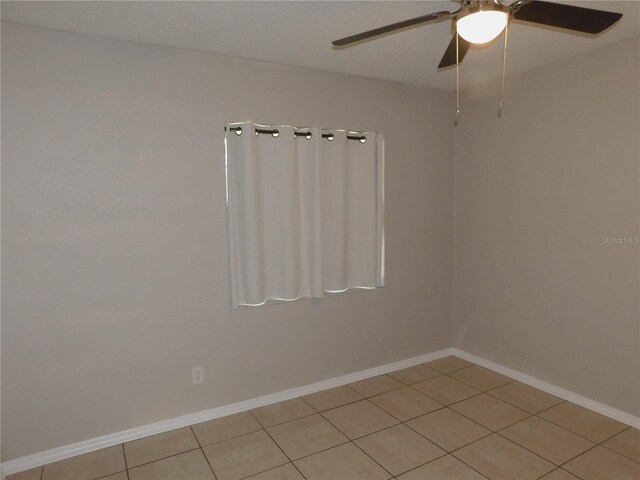 721 Town Ct Unit A & B, Bronson, FL 32621 - empty room with a ceiling fan, light tile patterned flooring, and baseboards