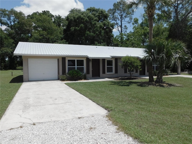721 Town Ct Unit A & B, Bronson, FL 32621 - single story home featuring stucco siding, concrete driveway, a garage, a front yard, and metal roof