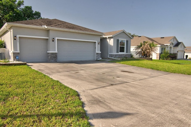 4261 SW 62nd Loop, Ocala, FL 34474 - ranch-style home with stone siding, a garage, stucco siding, concrete driveway, and a front yard