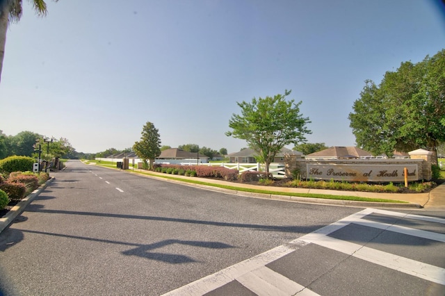 4261 SW 62nd Loop, Ocala, FL 34474 - view of asphalt road featuring curbs, street lights, sidewalks, and a residential view