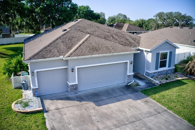4261 SW 62nd Loop, Ocala, FL 34474 - ranch-style home featuring stone siding, a garage, driveway, and stucco siding