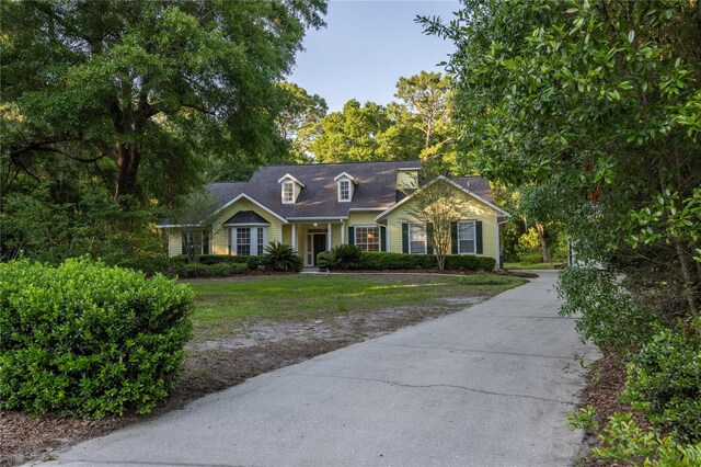 5802 SW 89th Ter, Gainesville, FL 32608 - cape cod-style house featuring driveway and a front lawn