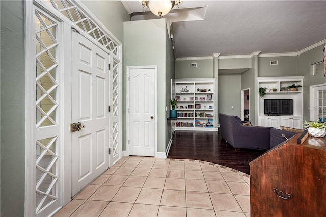 5802 SW 89th Ter, Gainesville, FL 32608 - entryway with light tile patterned floors, crown molding, and baseboards
