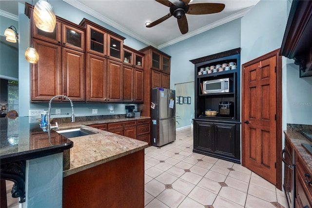 5802 SW 89th Ter, Gainesville, FL 32608 - kitchen featuring appliances with stainless steel finishes, a sink, a ceiling fan, ornamental molding, and a peninsula