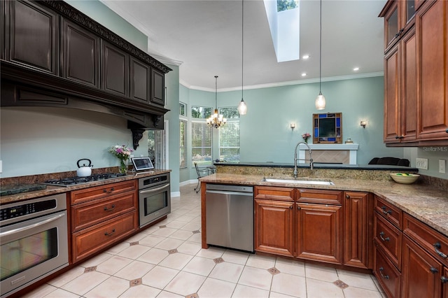 5802 SW 89th Ter, Gainesville, FL 32608 - kitchen featuring stainless steel appliances, a sink, a peninsula, decorative light fixtures, and a chandelier