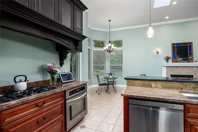 5802 SW 89th Ter, Gainesville, FL 32608 - kitchen with stainless steel appliances, crown molding, light tile patterned flooring, a chandelier, and decorative light fixtures