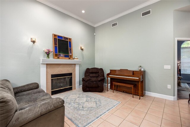 5802 SW 89th Ter, Gainesville, FL 32608 - living room with tile patterned floors, ornamental molding, a tiled fireplace, baseboards, and recessed lighting
