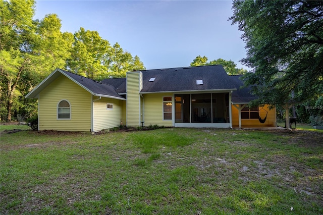 5802 SW 89th Ter, Gainesville, FL 32608 - rear view of house with a sunroom, a yard, and a chimney