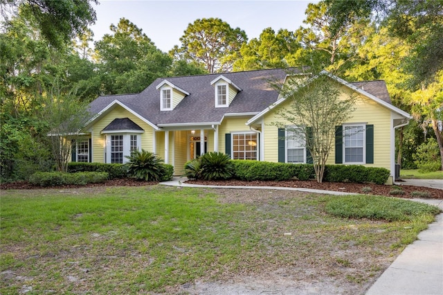 5802 SW 89th Ter, Gainesville, FL 32608 - new england style home with a front yard and a shingled roof