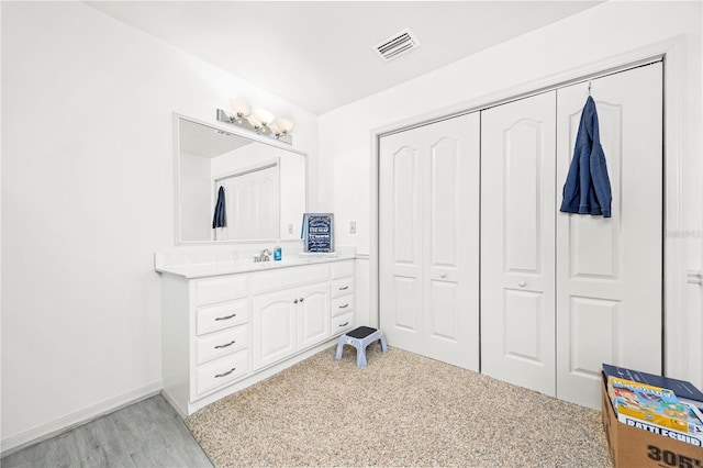 8968 122nd St, Live Oak, FL 32060 - bathroom with vanity, baseboards, and wood finished floors