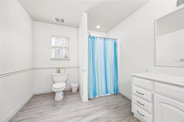 8968 122nd St, Live Oak, FL 32060 - full bathroom with vanity, toilet, wood finished floors, curtained shower, and baseboards