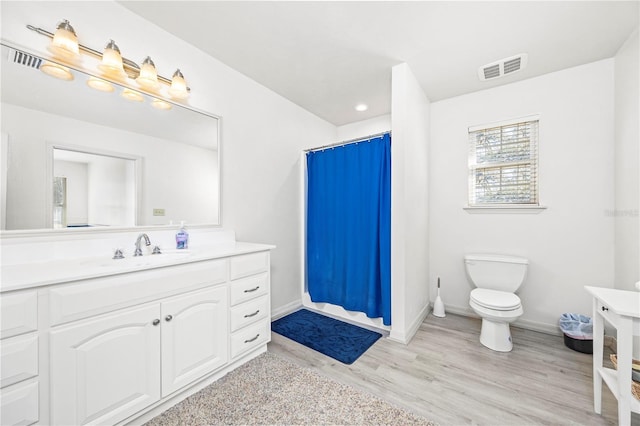 8968 122nd St, Live Oak, FL 32060 - bathroom featuring vanity, wood finished floors, toilet, baseboards, and a shower with curtain