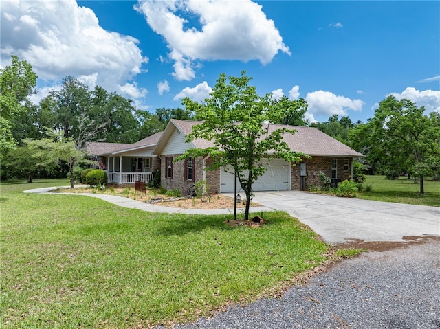 8968 122nd St, Live Oak, FL 32060 - single story home with covered porch, concrete driveway, a front yard, an attached garage, and brick siding