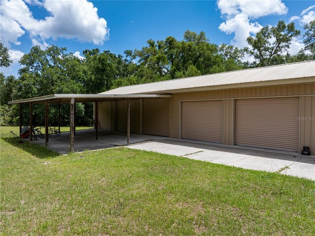8968 122nd St, Live Oak, FL 32060 - view of vehicle parking with a detached garage