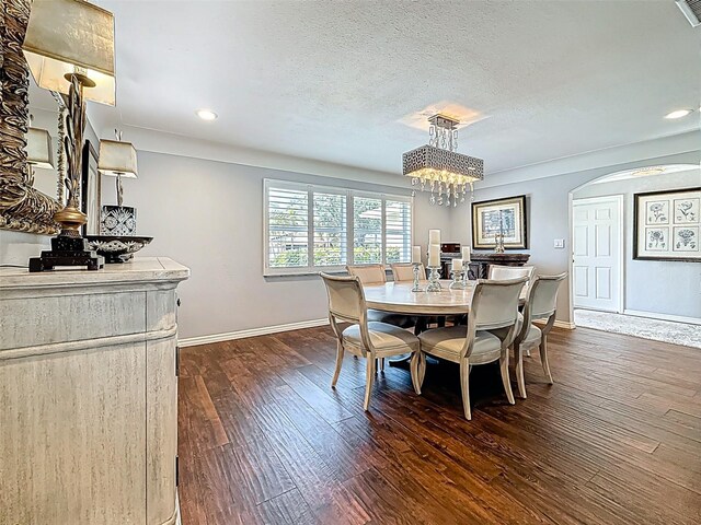 1120 81st St S, Saint Petersburg, FL 33707 - dining space with arched walkways, baseboards, dark wood finished floors, recessed lighting, and a chandelier