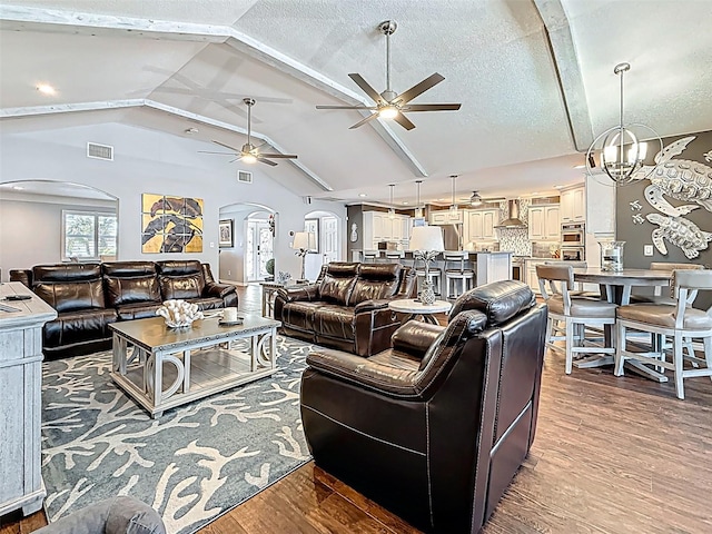 1120 81st St S, Saint Petersburg, FL 33707 - living area featuring arched walkways, ceiling fan, vaulted ceiling, and wood finished floors
