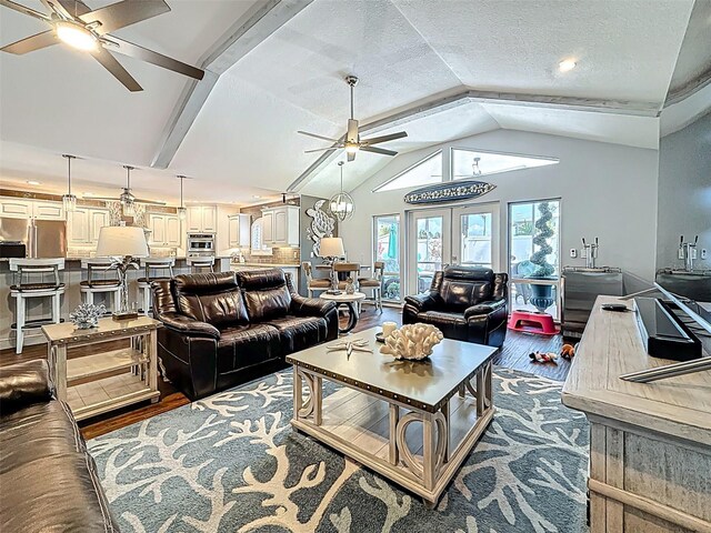 1120 81st St S, Saint Petersburg, FL 33707 - living room featuring ceiling fan, dark wood-type flooring, vaulted ceiling, and a textured ceiling