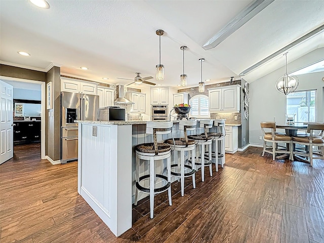 1120 81st St S, Saint Petersburg, FL 33707 - kitchen featuring stainless steel fridge, wall chimney exhaust hood, dark wood-style floors, healthy amount of natural light, and recessed lighting