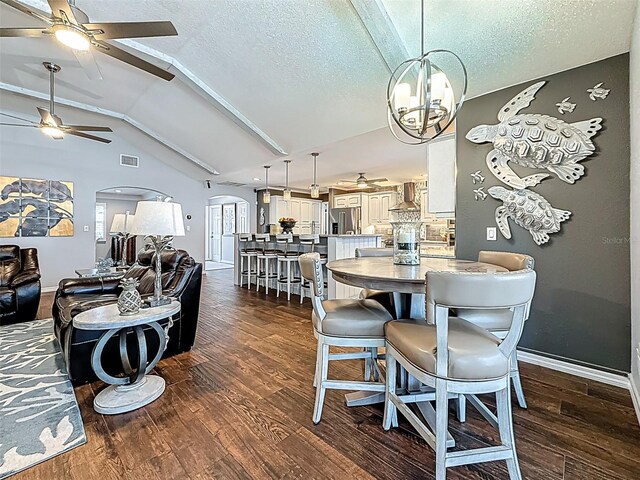 1120 81st St S, Saint Petersburg, FL 33707 - dining space featuring arched walkways, dark wood finished floors, ceiling fan, lofted ceiling, and baseboards