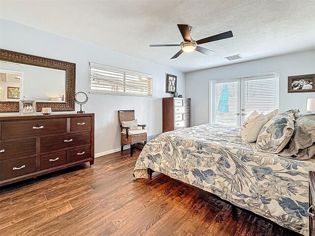 1120 81st St S, Saint Petersburg, FL 33707 - bedroom with dark wood-style floors, baseboards, a textured ceiling, and ceiling fan