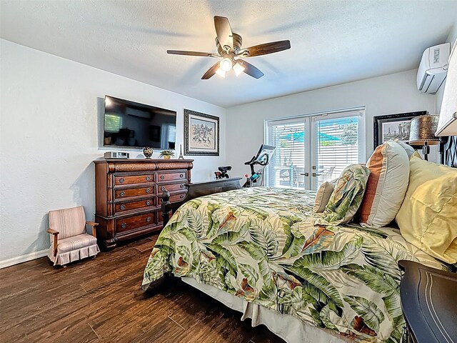1120 81st St S, Saint Petersburg, FL 33707 - bedroom with a wall mounted air conditioner, dark wood-type flooring, a ceiling fan, a textured ceiling, and baseboards
