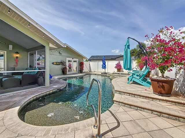 1120 81st St S, Saint Petersburg, FL 33707 - view of swimming pool featuring a patio area and a fenced backyard