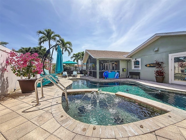 1120 81st St S, Saint Petersburg, FL 33707 - view of swimming pool featuring a patio area, a pool with connected hot tub, a sunroom, and a fenced backyard