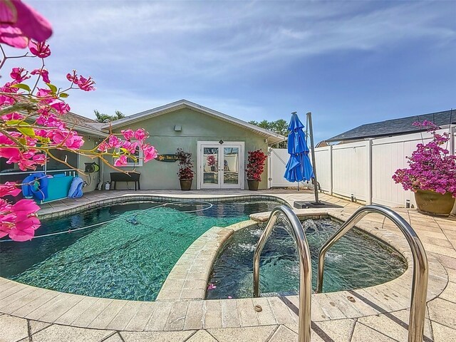 1120 81st St S, Saint Petersburg, FL 33707 - view of pool with french doors, a fenced backyard, a patio, and a pool with connected hot tub