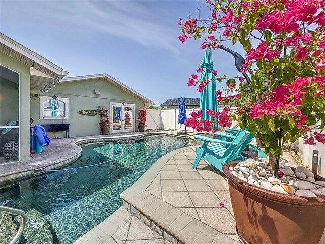 1120 81st St S, Saint Petersburg, FL 33707 - view of pool with french doors, a fenced backyard, and a patio