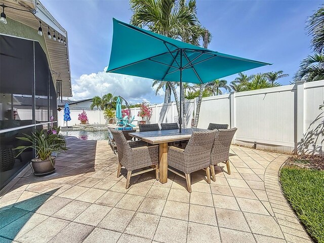 1120 81st St S, Saint Petersburg, FL 33707 - view of patio featuring a fenced backyard and outdoor dining area