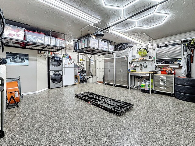 1120 81st St S, Saint Petersburg, FL 33707 - garage with stacked washer and clothes dryer, baseboards, freestanding refrigerator, a garage door opener, and a workshop area