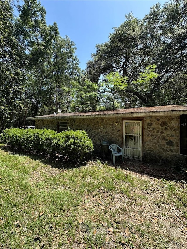 15750 NE 150th Ter, Fort Mc Coy, FL 32134 - back of house with stone siding