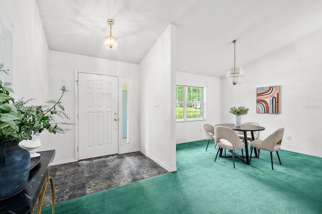 3233 SW 125th St, Archer, FL 32618 - entryway featuring vaulted ceiling, baseboards, dark carpet, and a chandelier