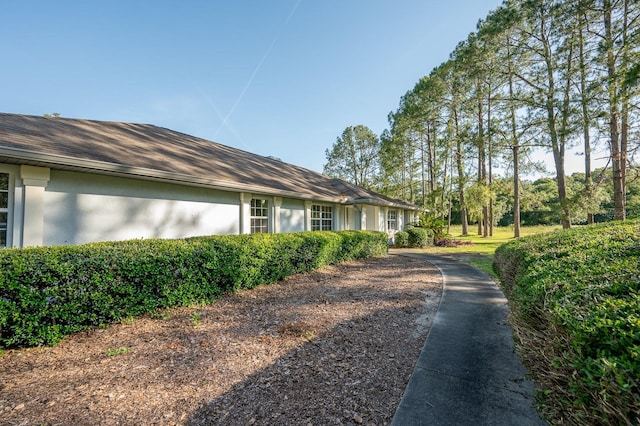 3233 SW 125th St, Archer, FL 32618 - view of home's exterior with stucco siding and driveway