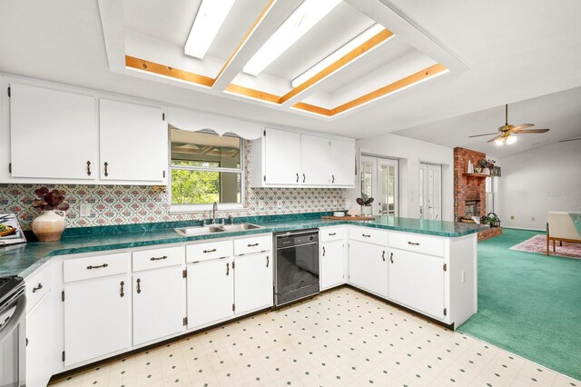 3233 SW 125th St, Archer, FL 32618 - kitchen with black dishwasher, a sink, a peninsula, dark countertops, and white cabinetry