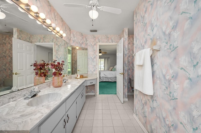 3233 SW 125th St, Archer, FL 32618 - full bath with wallpapered walls, tile patterned flooring, double vanity, connected bathroom, and ceiling fan