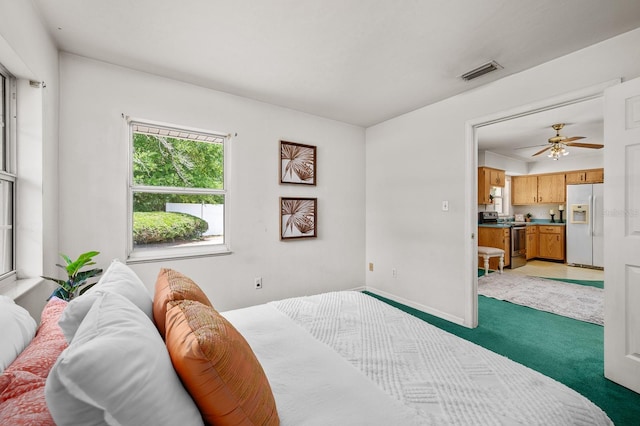 3233 SW 125th St, Archer, FL 32618 - bedroom with white fridge with ice dispenser, light carpet, and baseboards