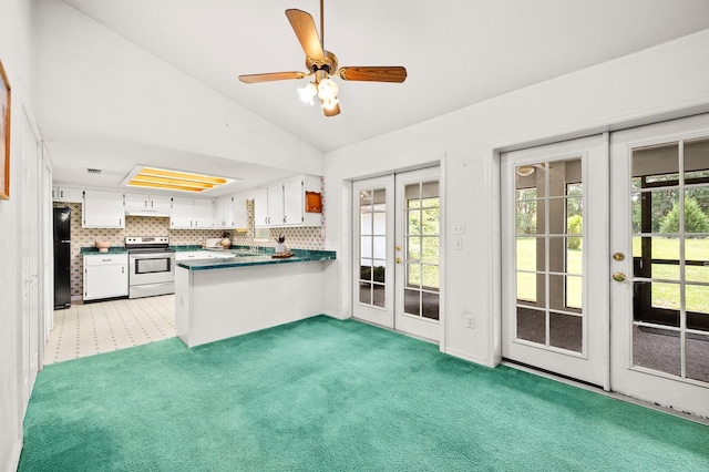 3233 SW 125th St, Archer, FL 32618 - kitchen with french doors, electric range, freestanding refrigerator, vaulted ceiling, and a peninsula