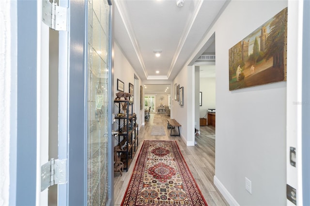 hall with light wood finished floors and baseboards