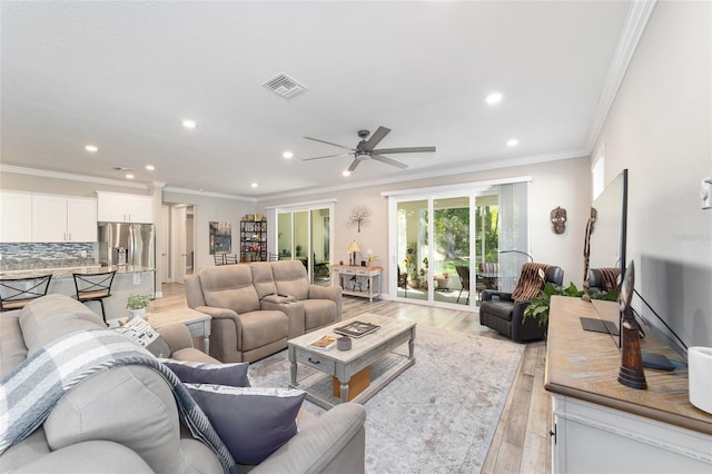 living area with light wood-type flooring, recessed lighting, ceiling fan, and crown molding